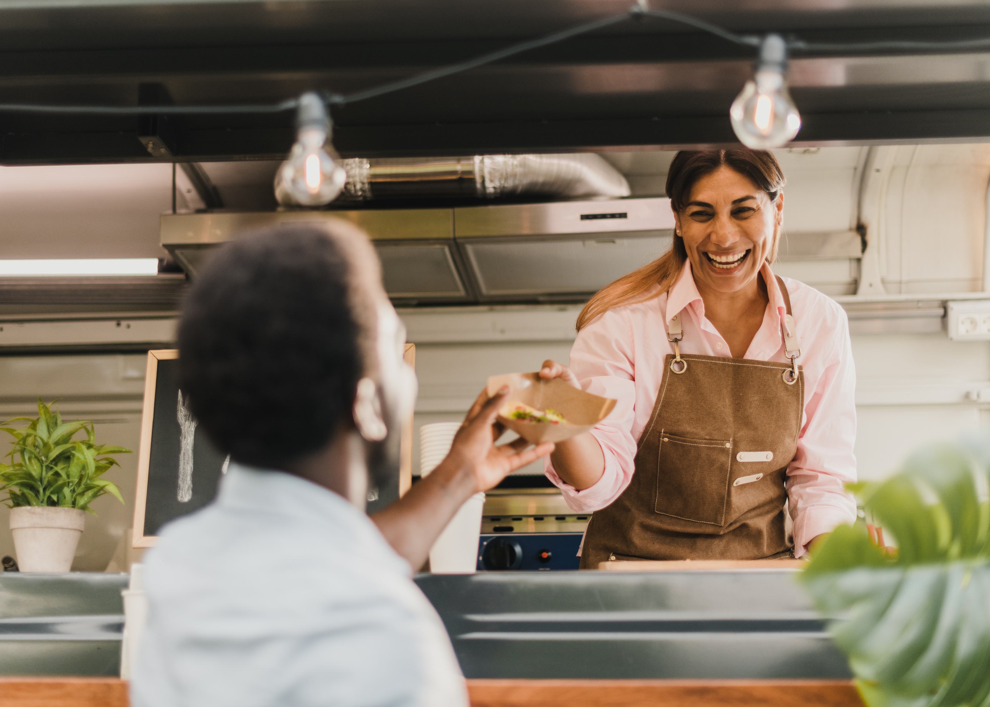 Small Company Owner Serving a Customer